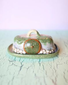 a green and white container sitting on top of a wooden table