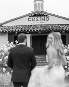 black and white photo of bride and groom in front of the casino san clemente