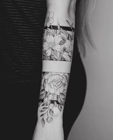 a woman's arm with flowers on it