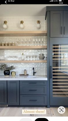 a kitchen with gray cabinets and white counter tops, along with an ad for the appliance