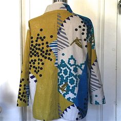 a jacket is hanging on a door with an animal in the back and dots all over it