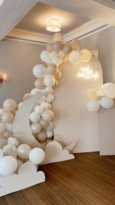 white balloons are floating in the air near a staircase