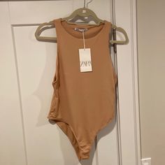 New With Tags Zara Tan Bodysuit Chic Sleeveless Bodysuit For Beach Season, Chic Zara One-piece Bodysuit, Spring Sleeveless Beachwear Bodysuit, Chic One-piece Bodysuit By Zara, Zara Stretch Bodysuit For Spring, Zara Trendy Sleeveless Bodysuit, Trendy Zara Sleeveless Bodysuit, Zara Summer Bodysuit, Trendy Sleeveless Zara Bodysuit