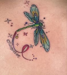 a dragonfly tattoo on the back of a woman's upper back and chest