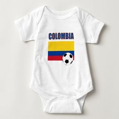 a baby bodysuit with a soccer ball in the colors of colombia on it's chest