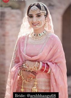 a woman in a pink bridal outfit with jewelry on her head and the words bride @