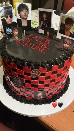 a cake decorated with pictures and photos on it's side, sitting on a table