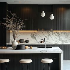 a kitchen with marble counter tops and stools next to an island in the middle