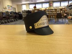 a black hat sitting on top of a wooden table