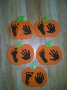 some fake pumpkins with hand prints on them