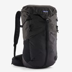 the patagon backpack in black and grey is shown from the front, with zippers at the bottom