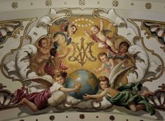 an artistic painting on the ceiling of a building with angels and a globe in it