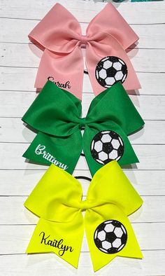 four bows with soccer balls and name on them