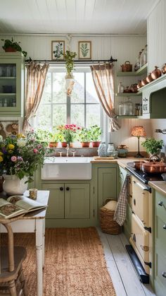 a kitchen filled with lots of green cupboards and counter top next to a window