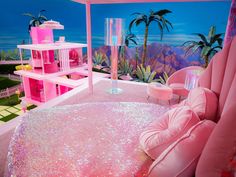 a bedroom with pink furniture and palm trees in the background at night time, it looks like a barbie doll's house