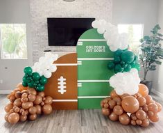 football themed balloon arch with balloons in the shape of an american football field and ball