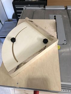 a piece of plywood being cut with a circular sawtoother on the table