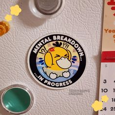 a sticker on the back of a refrigerator that says mental break down in progress