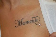 a woman's stomach with the word mamma tattooed on her left side chest