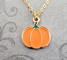 "This listing is for an orange pumpkin pendant necklace. You'll be able to choose your chain length and style at checkout by using the \"Chain Length/Style\" drop-down menu. Keyrings, bangle bracelets, ball chains, and black/brown leather and suede cord are also available. **Please see the second photo for scale! If you're on the mobile site, just swipe to the side. :) ITEM CARE: We recommend avoiding contact with water or moisture of any kind, for best results. - - - - - - - Sign up for our newsletter to receive coupons and updates on new items! Follow the link: ♦ ♦ ♦ http://eepurl.com/cG7GGT ♦ ♦ ♦ - - - - - - - This is our third shop for jewelry. If you're looking for something a bit more \"personalized\", then just follow these links: www.etsy.com/shop/metalspeak www.etsy.com/shop/metal Pumpkin Necklace Diy, Spooky Orange Jewelry For Gifts, Halloween Charm Necklace, Orange Novelty Halloween Jewelry, Pumpkin Necklace, Small Pumpkins, Suede Cord, Halloween Jewelry, Fall Jewelry