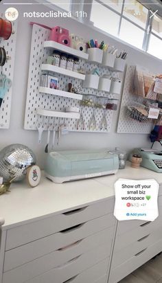 a sewing machine sitting on top of a white dresser next to a shelf filled with craft supplies