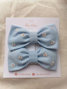 a blue bow with white flowers on it