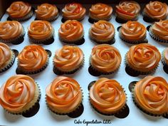 cupcakes with orange frosting in a box