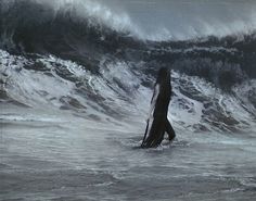 a woman standing in the middle of a body of water with large waves behind her