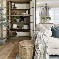 a living room filled with lots of furniture and decor on top of wooden flooring