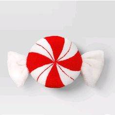 a red and white peppermint candy on a gray background