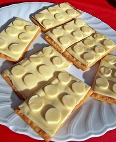 several pieces of cake on a plate with white icing and some slices cut into squares