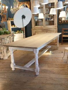 an old white table in a room with blue walls