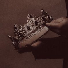 a person holding a crown in their hand