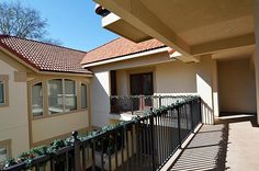 an apartment building with balconies and plants on the balcony