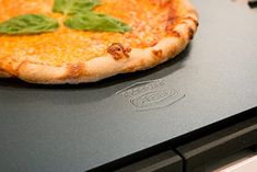 a pizza sitting on top of a laptop computer