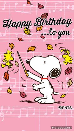 a happy birthday card with a cartoon dog holding a stick and falling leaves on it