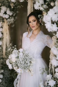 a woman in a wedding dress holding a bouquet