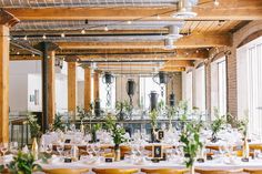 an indoor dining area with tables and chairs set up for a formal dinner or function