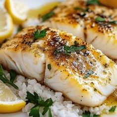 some fish and rice on a plate with lemons