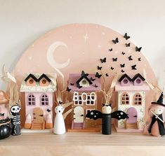 a group of halloween figurines sitting on top of a wooden table next to each other