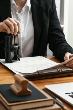 a woman sitting at a desk with a pen and paper