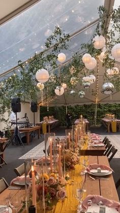 a table set up for an event with candles, plates and napkins on it