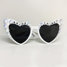 the bride to be sunglasses are decorated with pearls and black heart - shaped glasses,