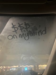 the back window of a car with graffiti on it's side and an upside down sign that says stop on my mind