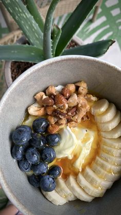 a bowl filled with fruit and nuts on top of a table