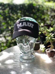 "These amazing visors all are such high quality!  This black visor is a fan favorite with the collegiate \"MAUI\" lettering!  We use clear Swarovski crystal on this piece!    This visor has a Velcro back to adjust the sizing." Mermaid Crowns, Head Crown, Lace Crowns, Mini Crown, Mermaid Crown, Lace Mermaid, Trucker Cap, Maui, Swarovski Crystal