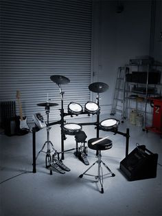 a set of drums sits in the middle of a room