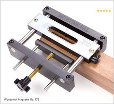 a woodworking machine with two pieces of wood attached to the handle and one piece being held