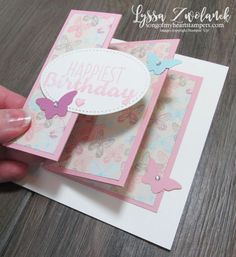 someone is holding up a birthday card with butterflies on the front and back of it