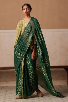 Emerald cotton saree with all over contrast spiral print, hand smocked details on pallu and contrast thread hand embroidery.
Components: 1
Pattern: Printed and Embroidered
Type Of Work: Spiral Print and Thread Work
Fabric: Cotton
Color: Emerald Green
Other Details: 
Contrast lace border
Model height: 5ft 6inches, wearing size S
Note: The top worn by the model is not for sale
Occasion: Puja,Mehendi and Haldi - Aza Fashions Saree With Top, Hand Painted Saree, Painted Saree, Smocking Patterns, Fashion Illustration Sketches Dresses, Hand Painted Sarees, Tarun Tahiliani, Sketches Dresses, Fashion Illustration Sketches